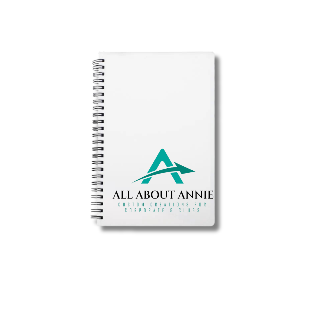 An A4 spiral notebook with a white cover, featuring the 'All About Annie' logo in teal.