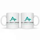 Two white ceramic mugs with the logo 'All About Annie' printed on the side.